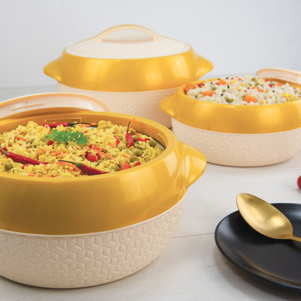 Yellow and beige ceramic hotpots with food on a white background
