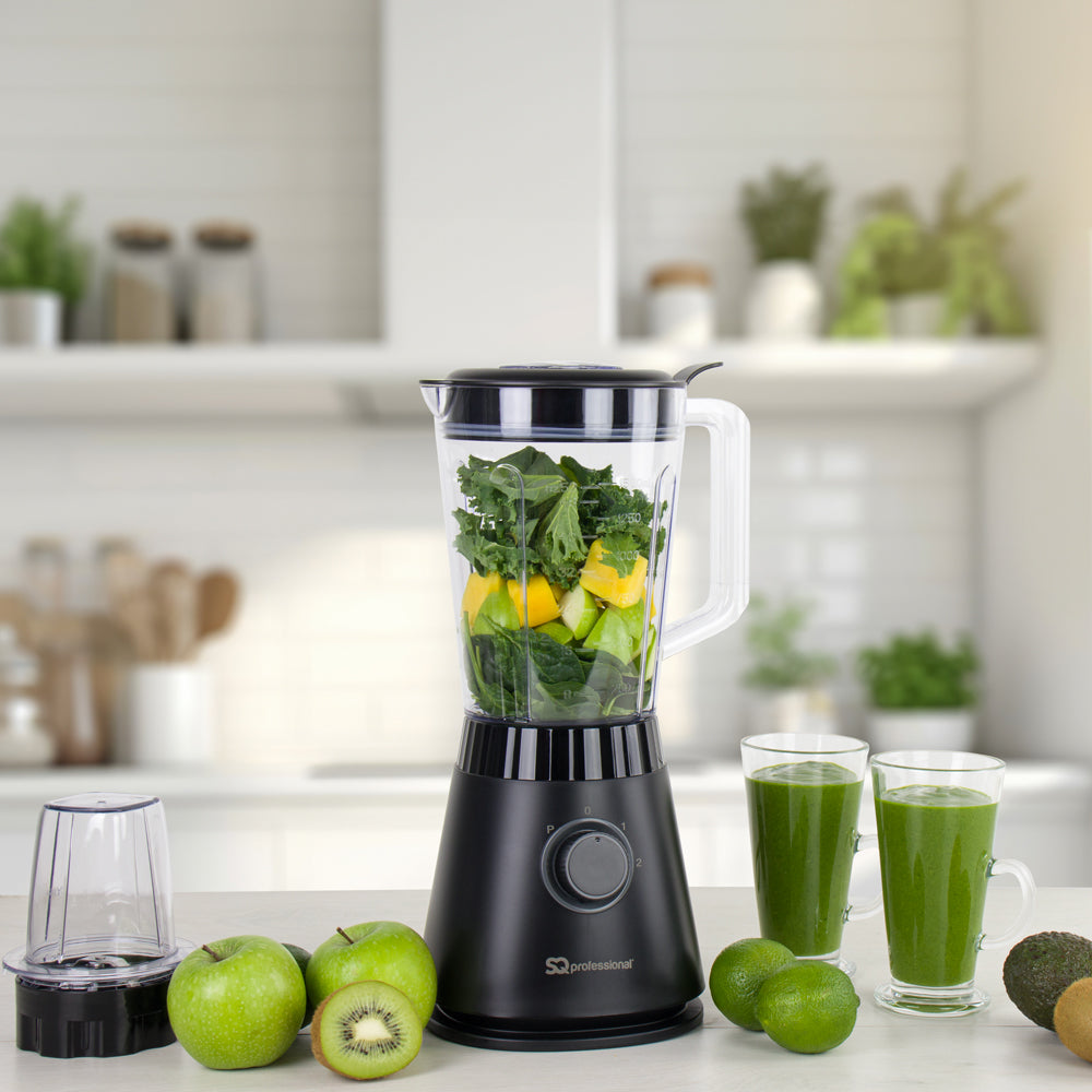 SQ Professional Blitz 600W Blender and Grinder on kitchen counter with fruits and green smoothie glasses